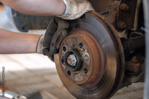 Mechanic changes the brake pads on the car