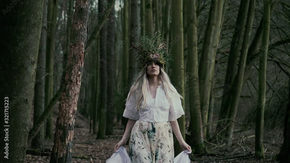 Beautiful natural fairy with white veil walking in forest, front dolly shot Beautiful natural fairy with white veil walking in forest, front dolly shot