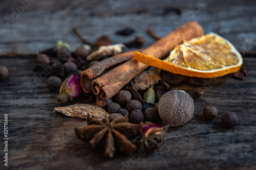 Dried oriental spices for the preparation of drinks on a wooden background. © YUABOG