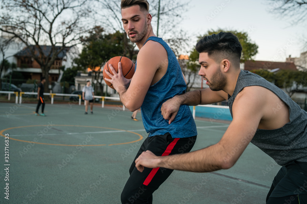 Fototapeta premium Young basketball players playing one-on-one.