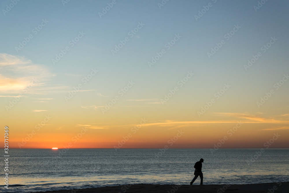 Silhouette of person photographing the sunset.