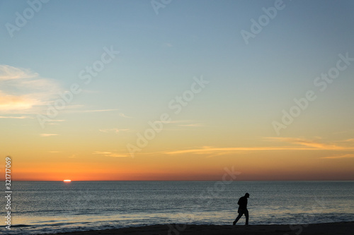 Silhouette of person photographing the sunset.