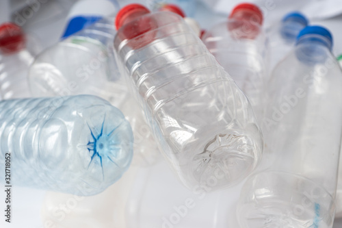 close up photo of transparent plastic bottles with caps of different colors, plastic pollution concept