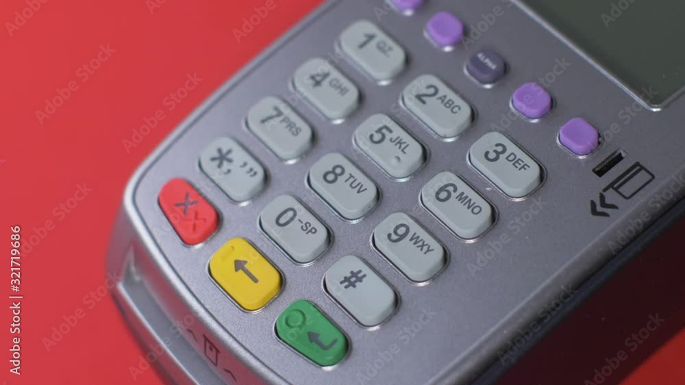 customer pays with a black phone through a gray terminal that is placed customer pays with a black phone through a gray terminal that is placed