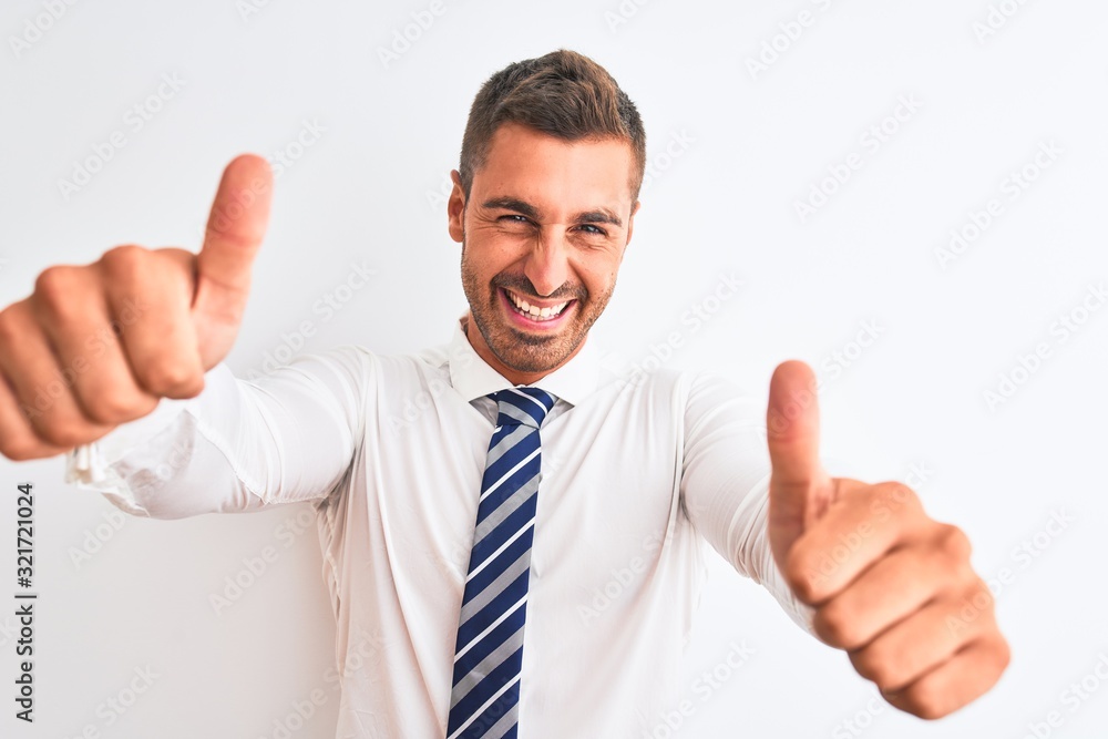 Young handsome elegant business man over isolated background approving doing positive gesture with hand, thumbs up smiling and happy for success. Winner gesture. Young handsome elegant business man over isolated background approving doing positive gesture with hand, thumbs up smiling and happy for success. Winner gesture.