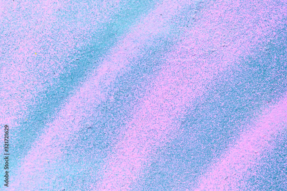 Abstract metal texture with a spray can of pink and blue paint.