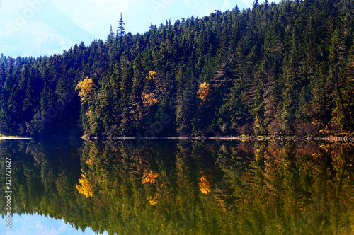 Lake with autumn forest reflected in the water