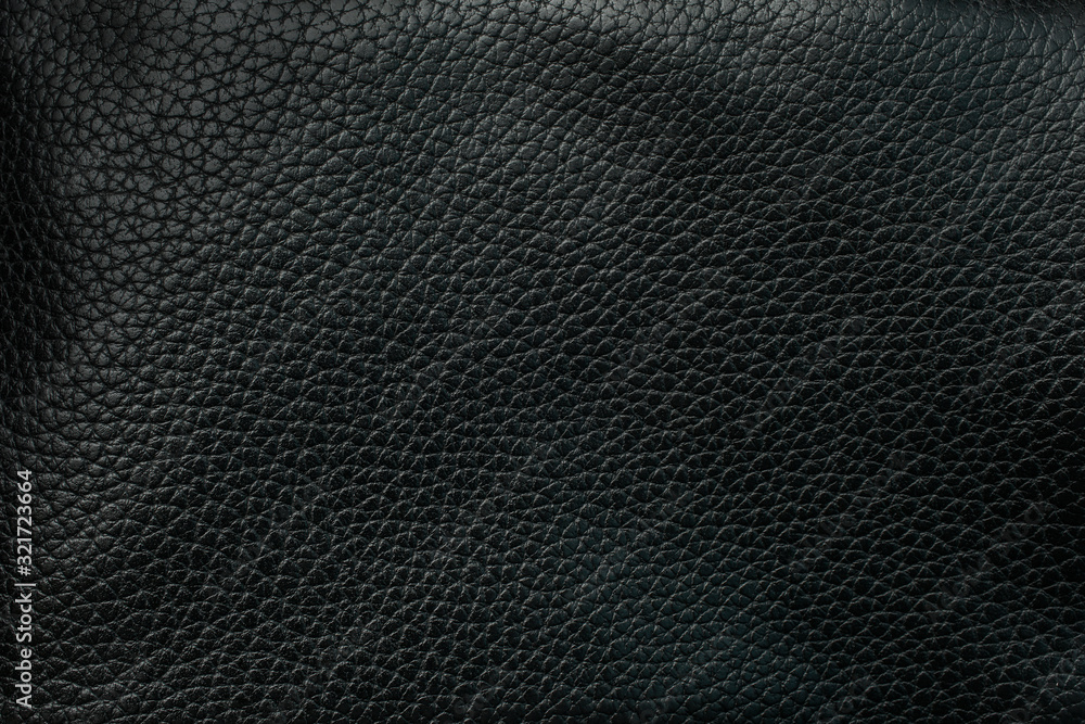 The texture of the two pieces stitched with threads of black skin . Dark background. Black skin as background The texture of the two pieces stitched with threads of black skin . Dark background. Black skin as background