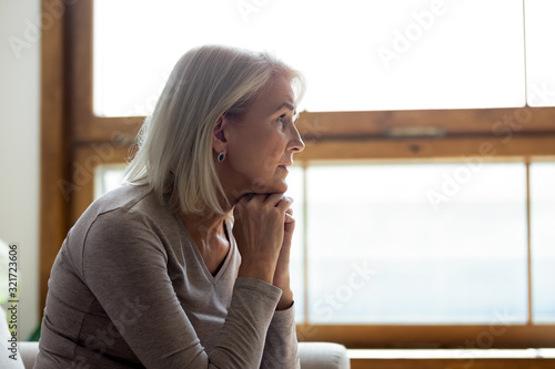 Obraz na plátně Upset mature woman look in distance feeling sad mourning
