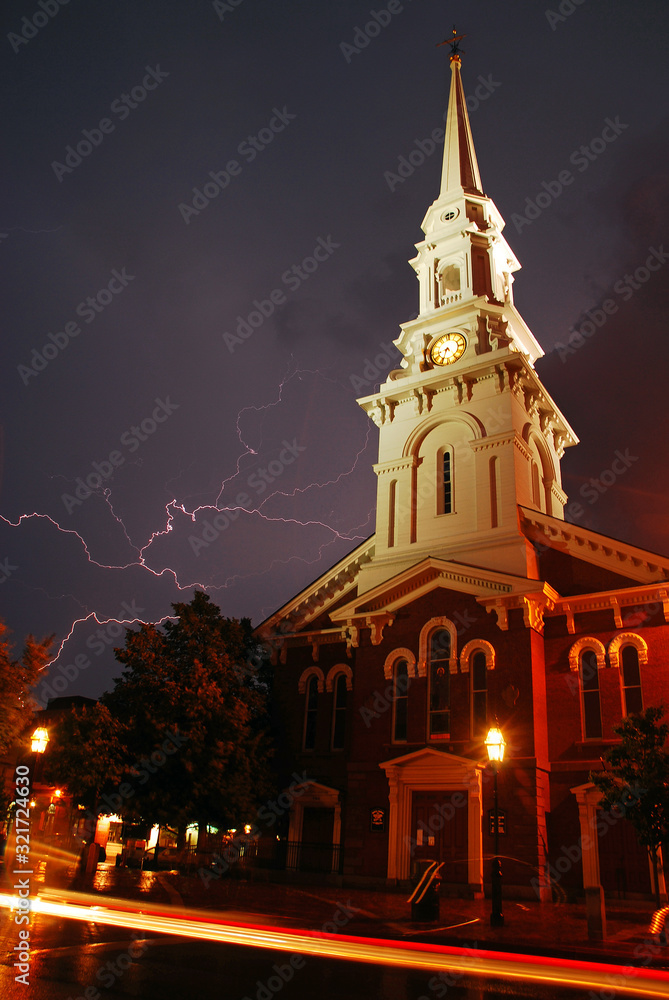 Lightning streaks across the stormy skies near a historic church