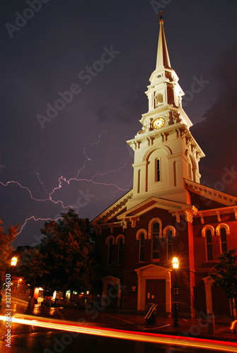 Lightning streaks across the stormy skies near a historic church