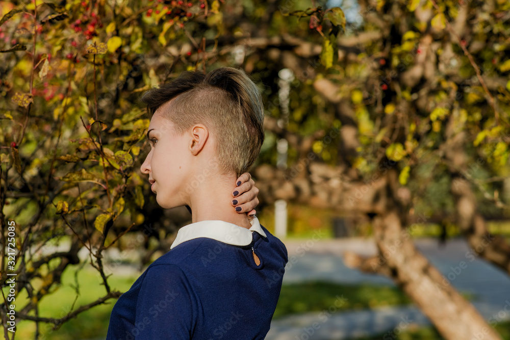 Trendy teen girl with short hair in autumn park Trendy teen girl with short hair in autumn park