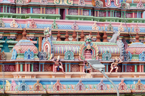 Multi colored gods and goddesses adorn the gopuram photo