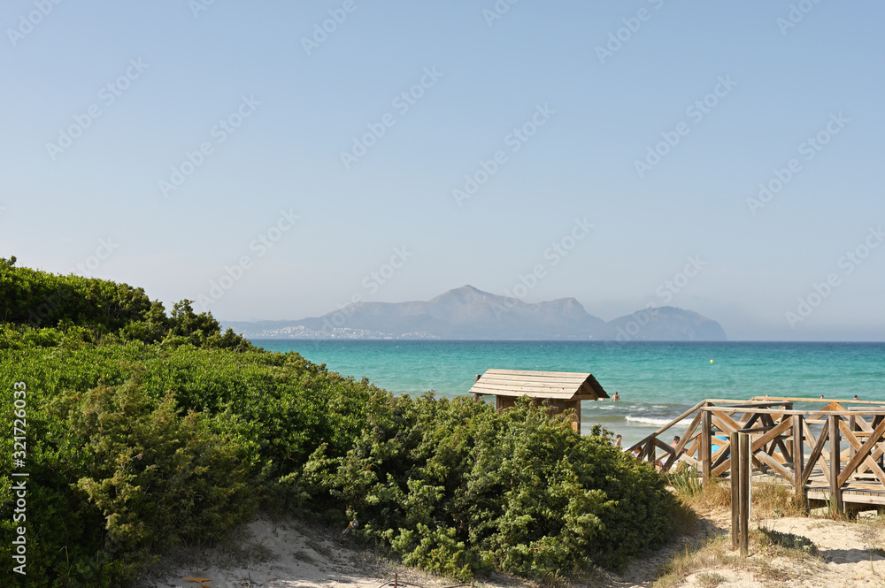 landscape, coast of the sea against the blue sky and mountains