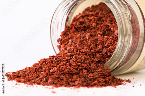 Ground Aleppo Peppers Spilled from a Spice Jar photo