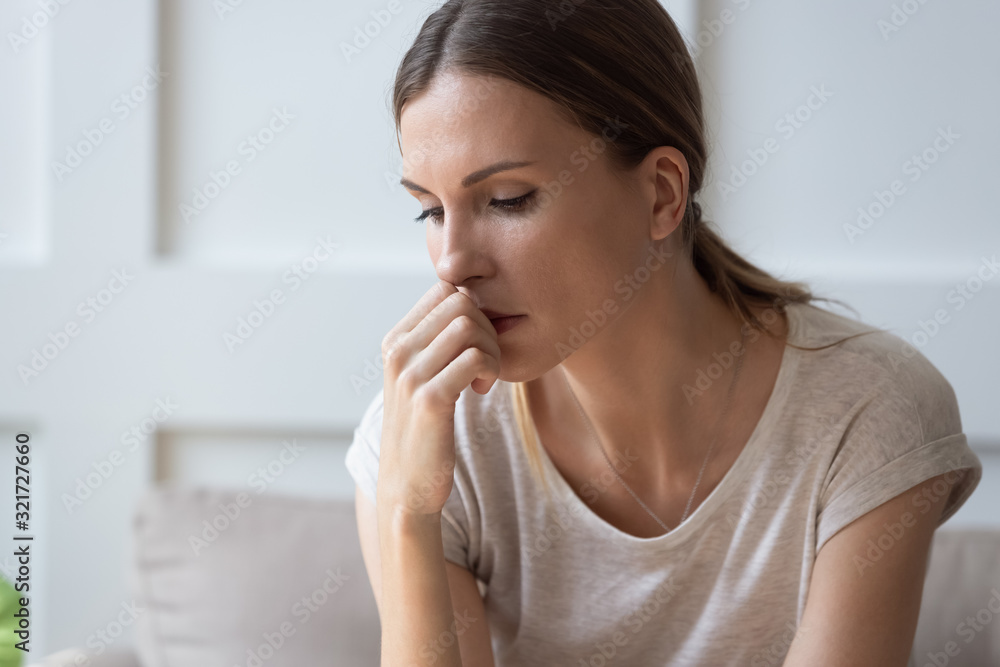 Upset young woman feel depressed thinking at home Upset young woman feel depressed thinking at home