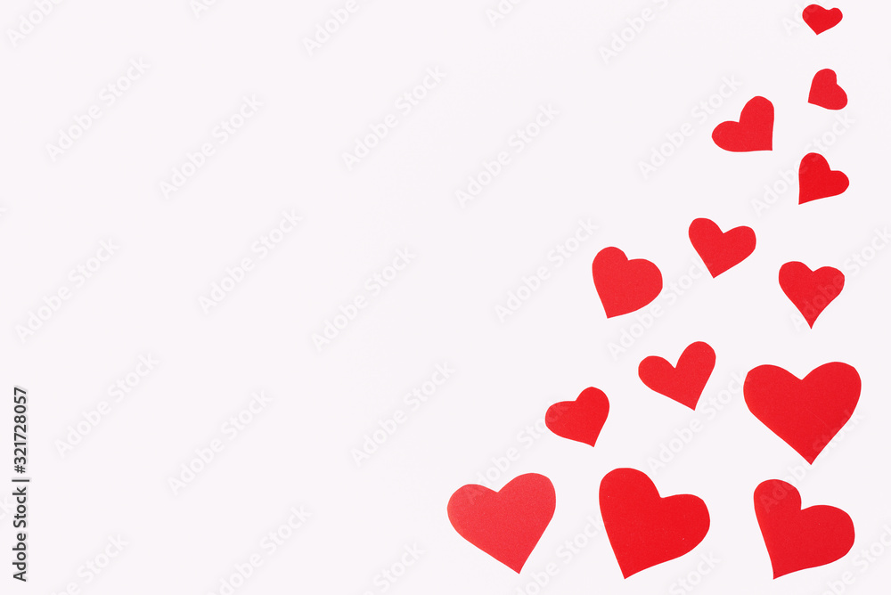 red hearts in bulk on a white background on the right side of the frame. Valentine's Day. Place for text