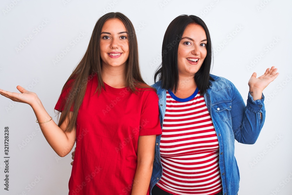 Young beautiful women wearing casual clothes standing over isolated white background smiling showing both hands open palms, presenting and advertising comparison and balance Young beautiful women wearing casual clothes standing over isolated white background smiling showing both hands open palms, presenting and advertising comparison and balance
