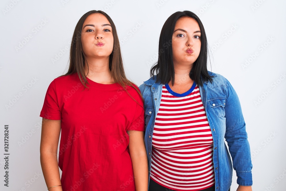 Young beautiful women wearing casual clothes standing over isolated white background puffing cheeks with funny face. Mouth inflated with air, crazy expression. Young beautiful women wearing casual clothes standing over isolated white background puffing cheeks with funny face. Mouth inflated with air, crazy expression.