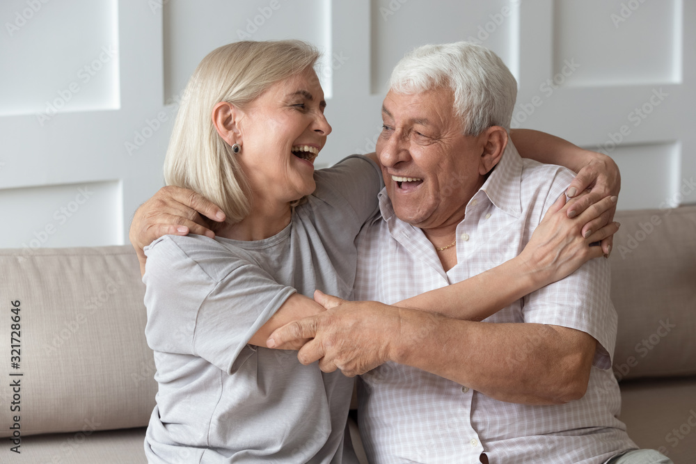 Funny elderly couple have fun laughing cuddling at home Funny elderly couple have fun laughing cuddling at home
