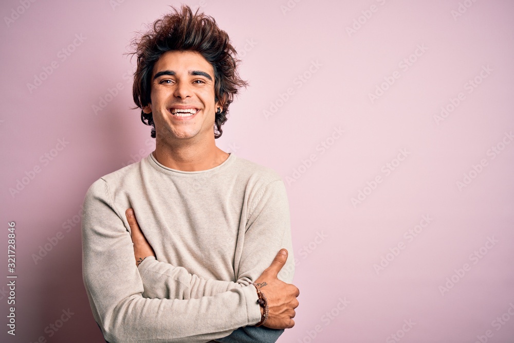 Young handsome man wearing casual t-shirt standing over isolated pink background happy face smiling with crossed arms looking at the camera. Positive person. Young handsome man wearing casual t-shirt standing over isolated pink background happy face smiling with crossed arms looking at the camera. Positive person.