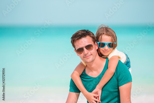 Little girl and happy dad having fun during beach vacation © travnikovstudio