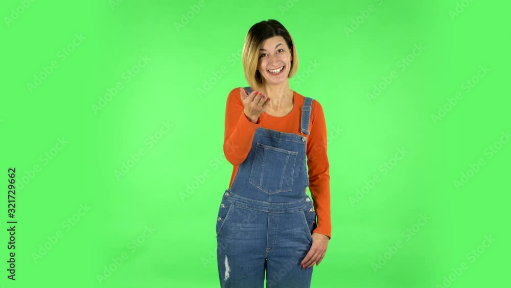 Happy woman waving hand and showing gesture come here. Green screen Happy woman waving hand and showing gesture come here. Green screen
