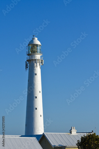 Tall White Lighthouse Tower Over Rooftops, Cape Town, South Africa
