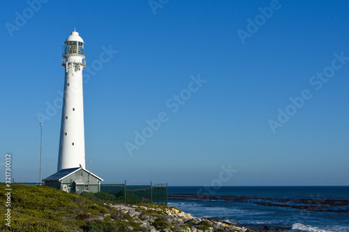 Tall White Lighthouse Overlooking The Ocean, Cape Town, South Africa