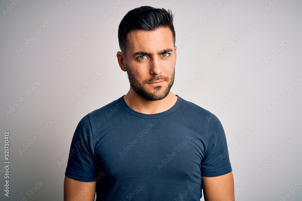 Young handsome man wearing casual t-shirt standing over isolated white background skeptic and nervous, frowning upset because of problem. Negative person. Young handsome man wearing casual t-shirt standing over isolated white background skeptic and nervous, frowning upset because of problem. Negative person.