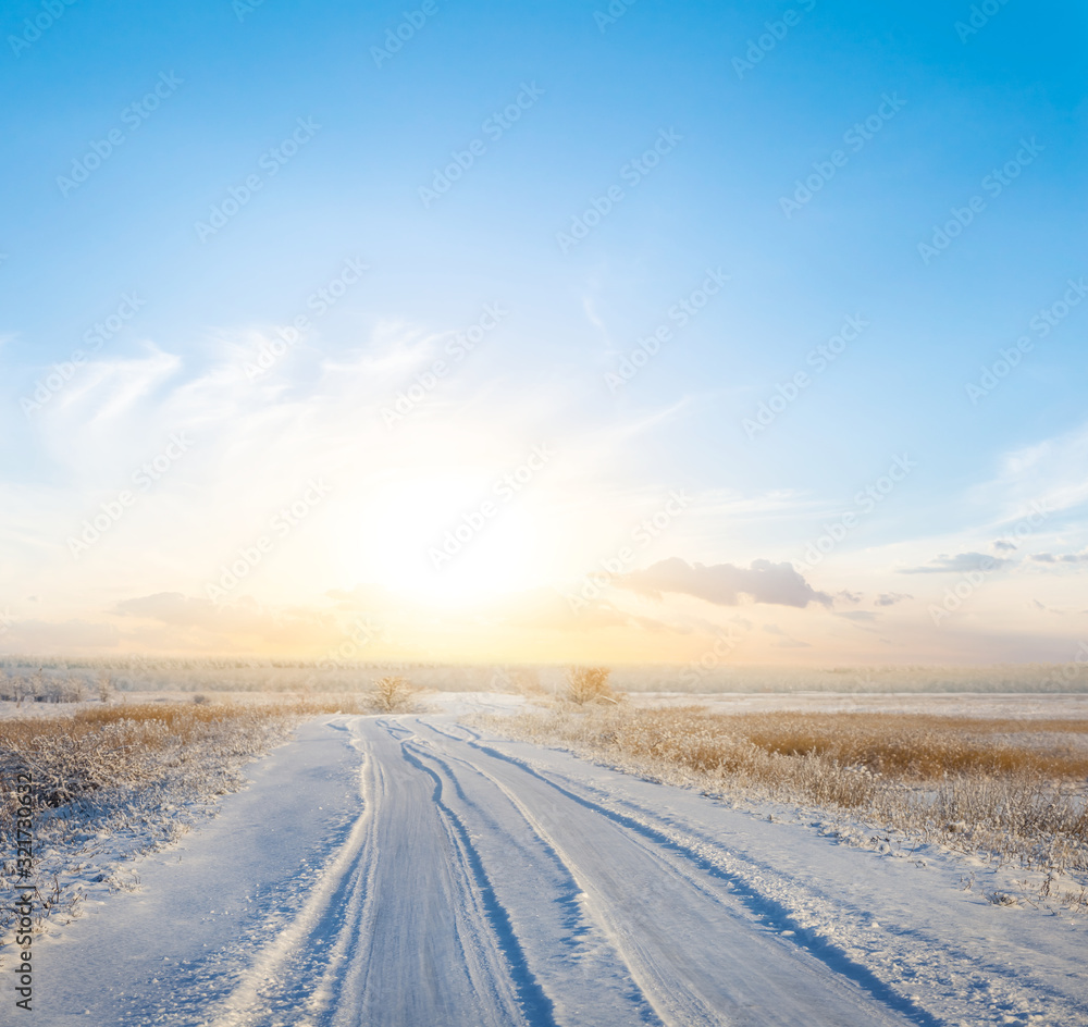 beautiful winter snowbound plain with road to sunset beautiful winter snowbound plain with road to sunset