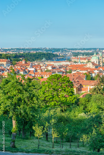 Top view to red roofs and green trees skyline of Prague city Czech republic.