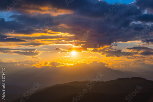 dramatic sunset over the mountain slope © Yuriy Kulik