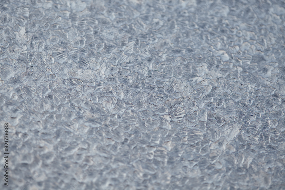 Texture of Frozen drops of condensed steam water drops on the transparent window glass. Clean background. Water vapor condenses on cold window glass and freezes into ice