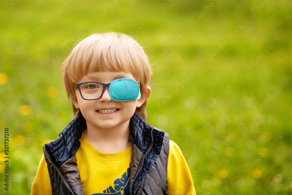 Portrait of a happy strabismus boy 4-5 years old. Spring park. Portrait of a happy strabismus boy 4-5 years old. Spring park.