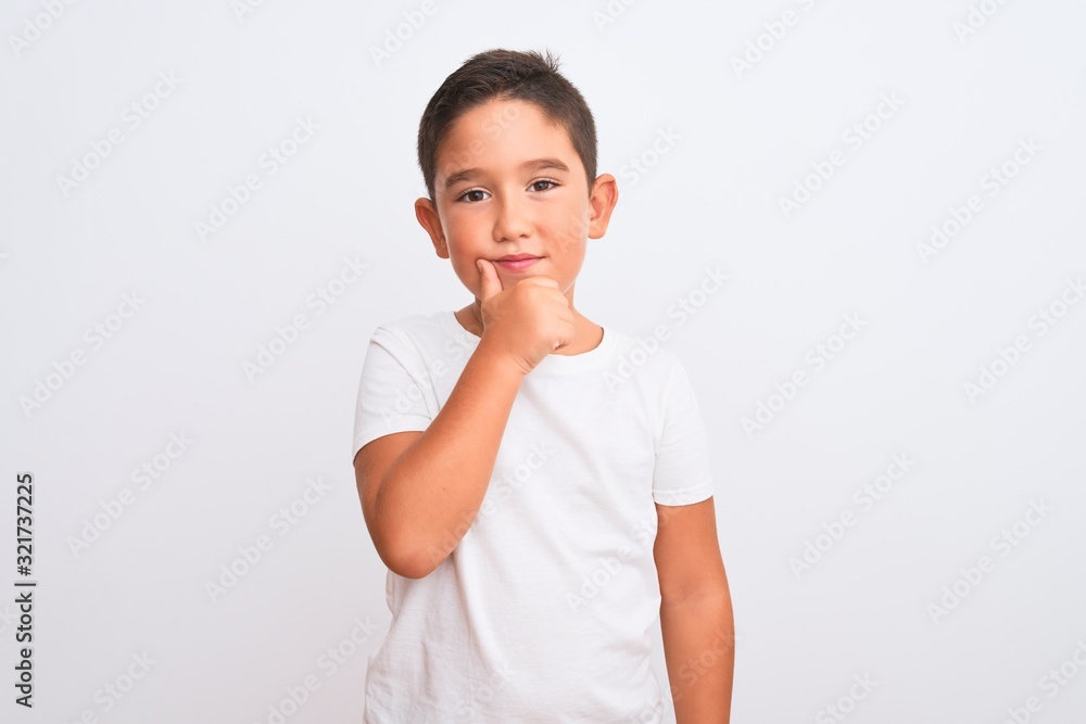 Beautiful kid boy wearing casual t-shirt standing over isolated white background looking confident at the camera with smile with crossed arms and hand raised on chin. Thinking positive. Beautiful kid boy wearing casual t-shirt standing over isolated white background looking confident at the camera with smile with crossed arms and hand raised on chin. Thinking positive.