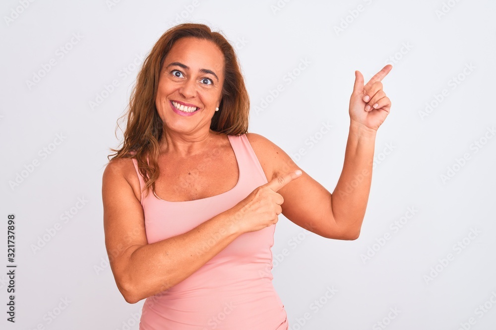Middle age mature woman standing over white isolated background smiling and looking at the camera pointing with two hands and fingers to the side. Middle age mature woman standing over white isolated background smiling and looking at the camera pointing with two hands and fingers to the side.