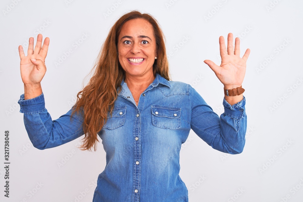 Middle age mature woman wearing denim jacket standing over white isolated background showing and pointing up with fingers number nine while smiling confident and happy. Middle age mature woman wearing denim jacket standing over white isolated background showing and pointing up with fingers number nine while smiling confident and happy.