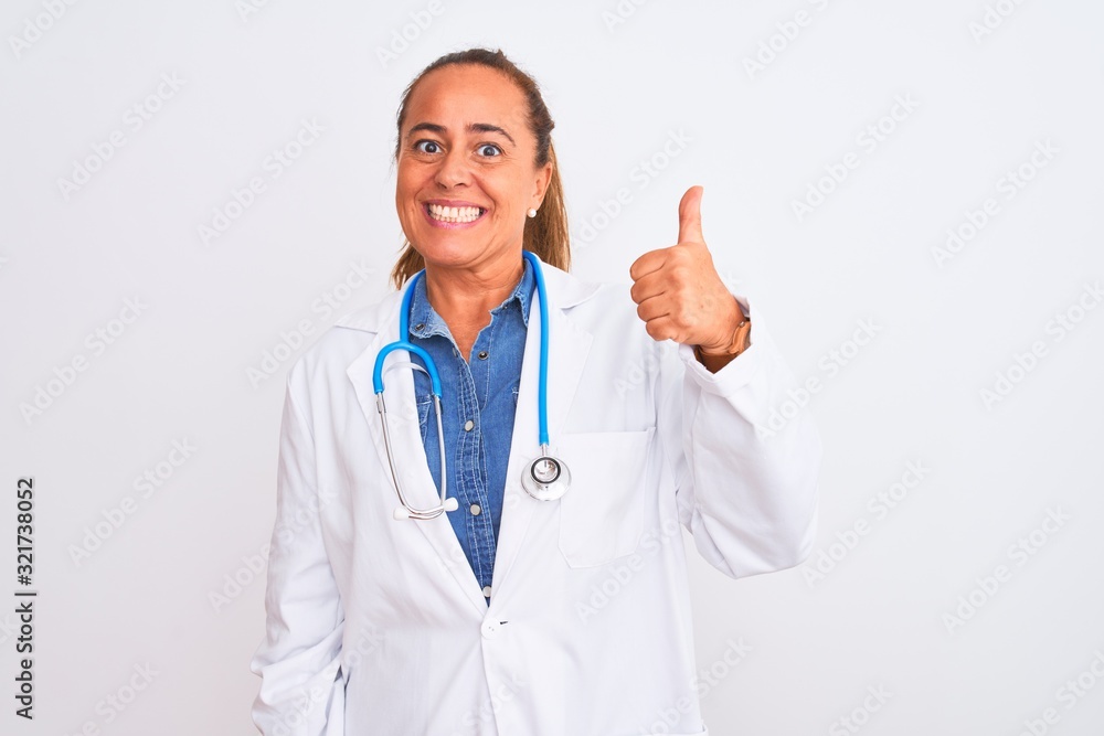 Middle age mature doctor woman wearing stethoscope over isolated background doing happy thumbs up gesture with hand. Approving expression looking at the camera showing success. Middle age mature doctor woman wearing stethoscope over isolated background doing happy thumbs up gesture with hand. Approving expression looking at the camera showing success.