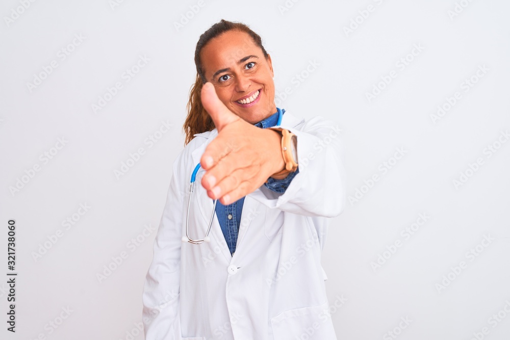 Middle age mature doctor woman wearing stethoscope over isolated background smiling friendly offering handshake as greeting and welcoming. Successful business. Middle age mature doctor woman wearing stethoscope over isolated background smiling friendly offering handshake as greeting and welcoming. Successful business.