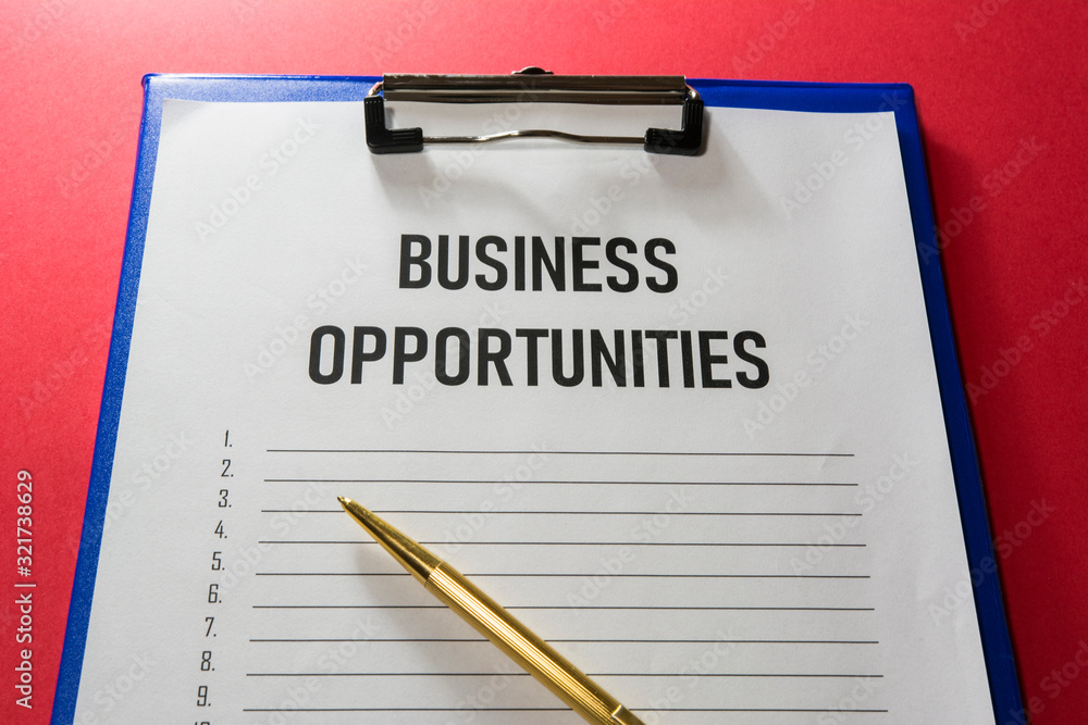 Business opportunity text on white paper with list lines and a gilded pen, concept. Business opportunity text on white paper with list lines and a gilded pen, concept.