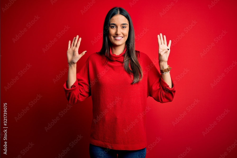 Young beautiful brunette woman wearing casual sweater over isolated red background showing and pointing up with fingers number nine while smiling confident and happy. Young beautiful brunette woman wearing casual sweater over isolated red background showing and pointing up with fingers number nine while smiling confident and happy.