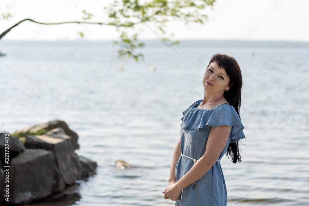 Portrait of a woman with long hair by the lake. Portrait of a woman with long hair by the lake.