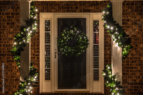 Entrance to the house illuminated with Christmas lights and decorations