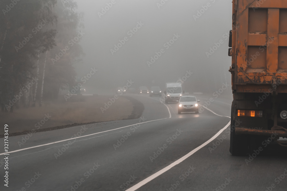 Driving car on heavy foggy day on country road. Poor visibility condition is dangerous for drivers. Driving car on heavy foggy day on country road. Poor visibility condition is dangerous for drivers.