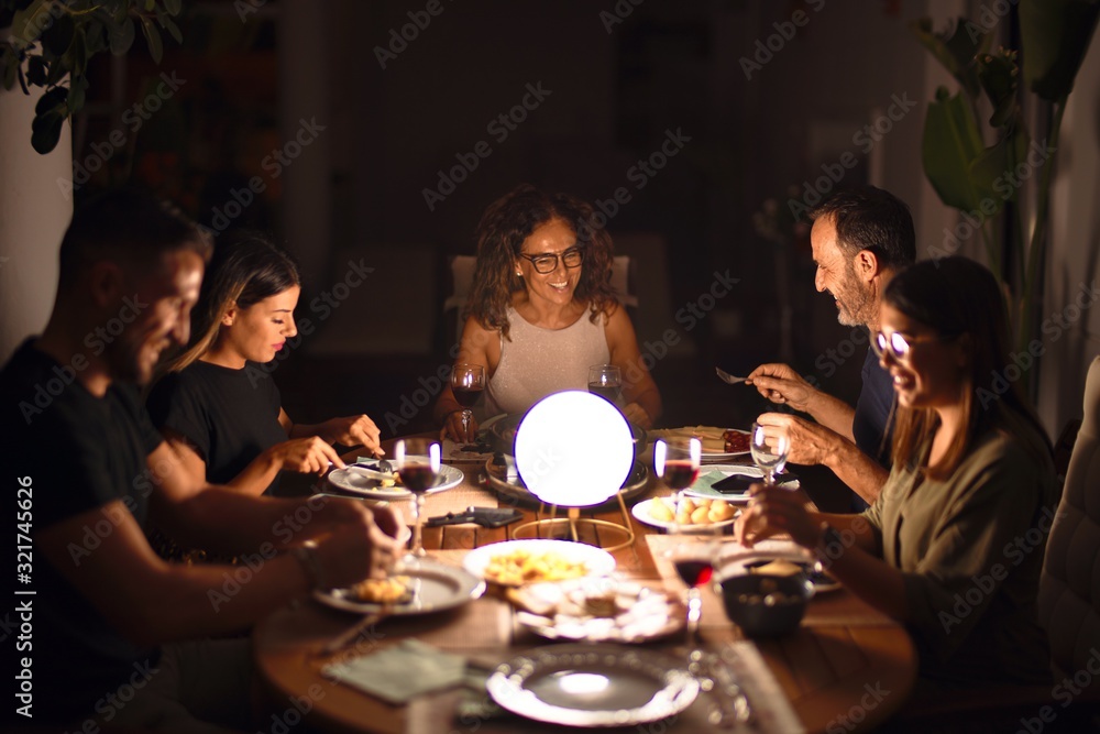 Beautiful family on dinner talking and smiling at terrace Beautiful family on dinner talking and smiling at terrace