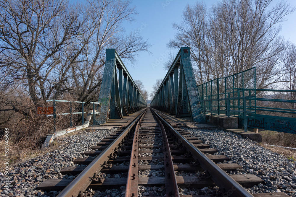 Green railroad bridge with tracks over river Green railroad bridge with tracks over river