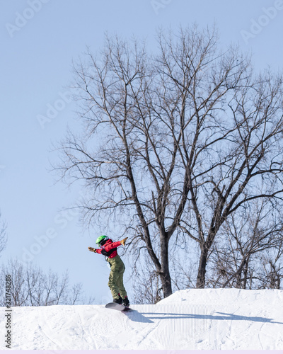 People are enjoying downhill skiing and snowboarding 