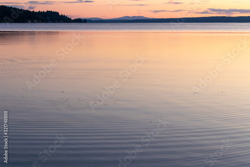 calm clean water of the puget sound with colorful sunset