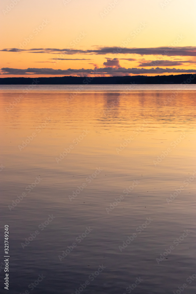 calm clean water of the puget sound with colorful sunset